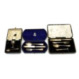 A cased silver christening set,