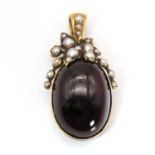 A Victorian cabochon garnet and split pearl pendant,