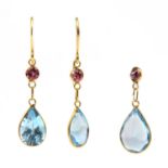 A gold blue topaz and garnet earrings and pendant suite,