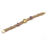 An Edwardian four row citrine and amethyst gate bracelet,