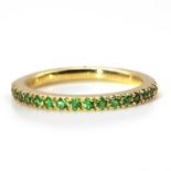 A gold tsavorite garnet half eternity ring,