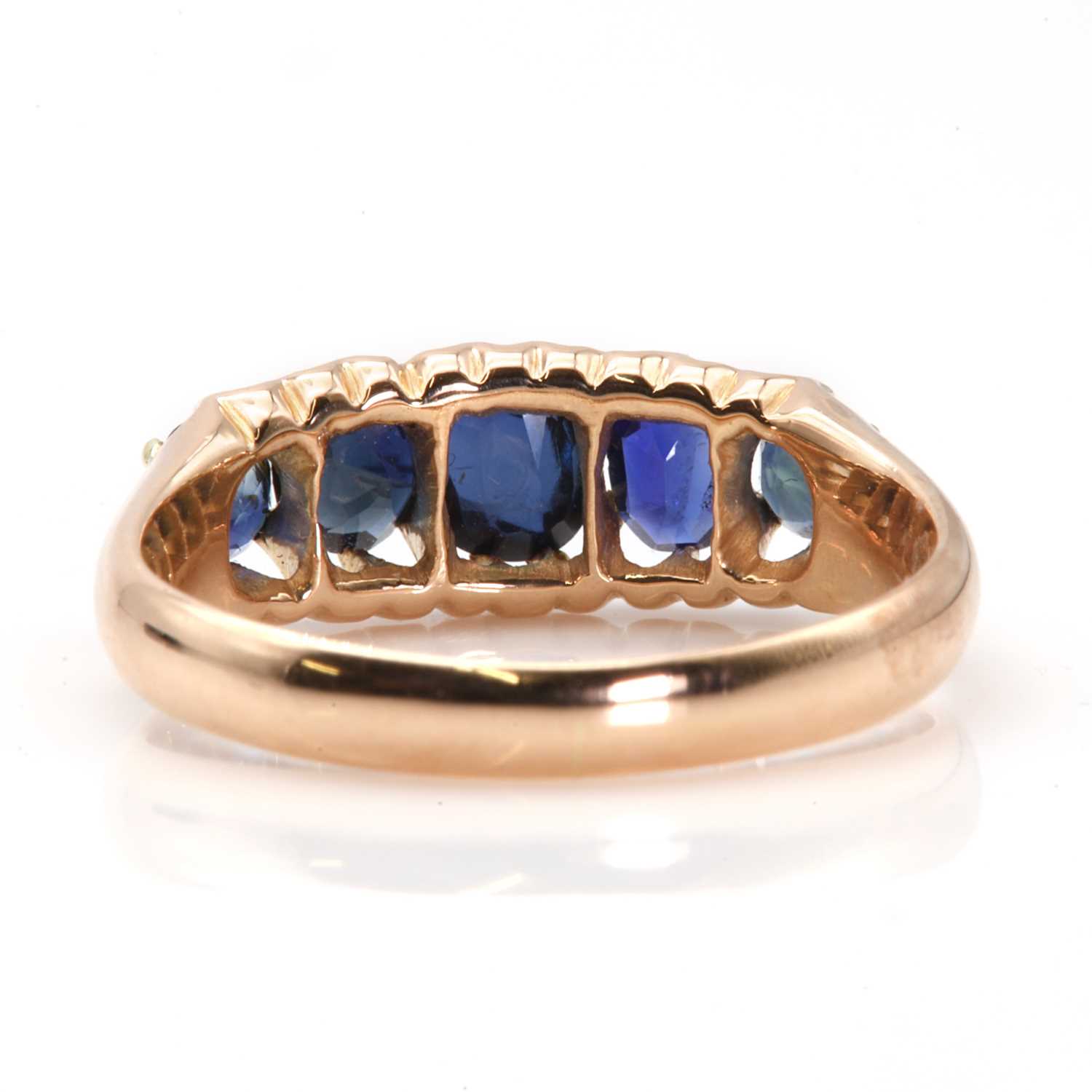 An Edwardian rose gold graduated five stone sapphire boat shaped ring, - Image 2 of 3