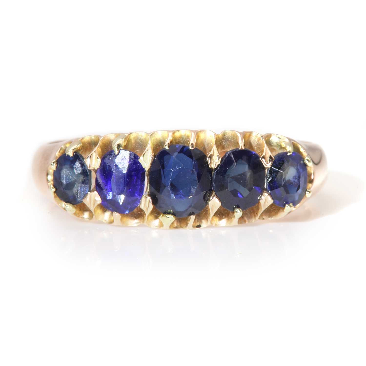An Edwardian rose gold graduated five stone sapphire boat shaped ring,