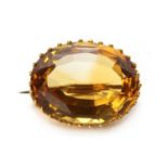 A gold single stone citrine brooch,
