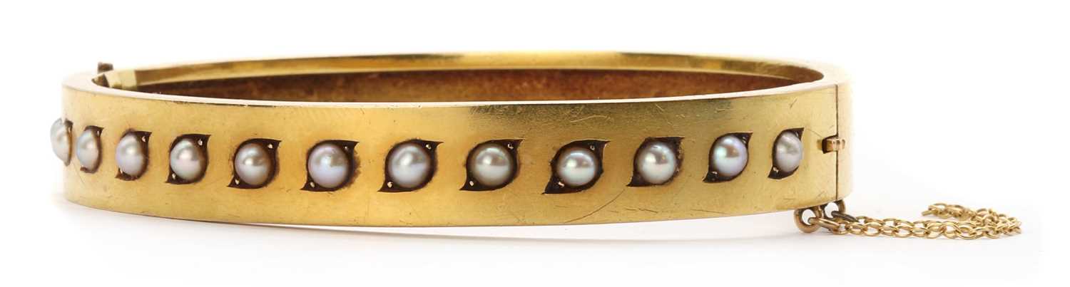 A Victorian gold split pearl bangle,