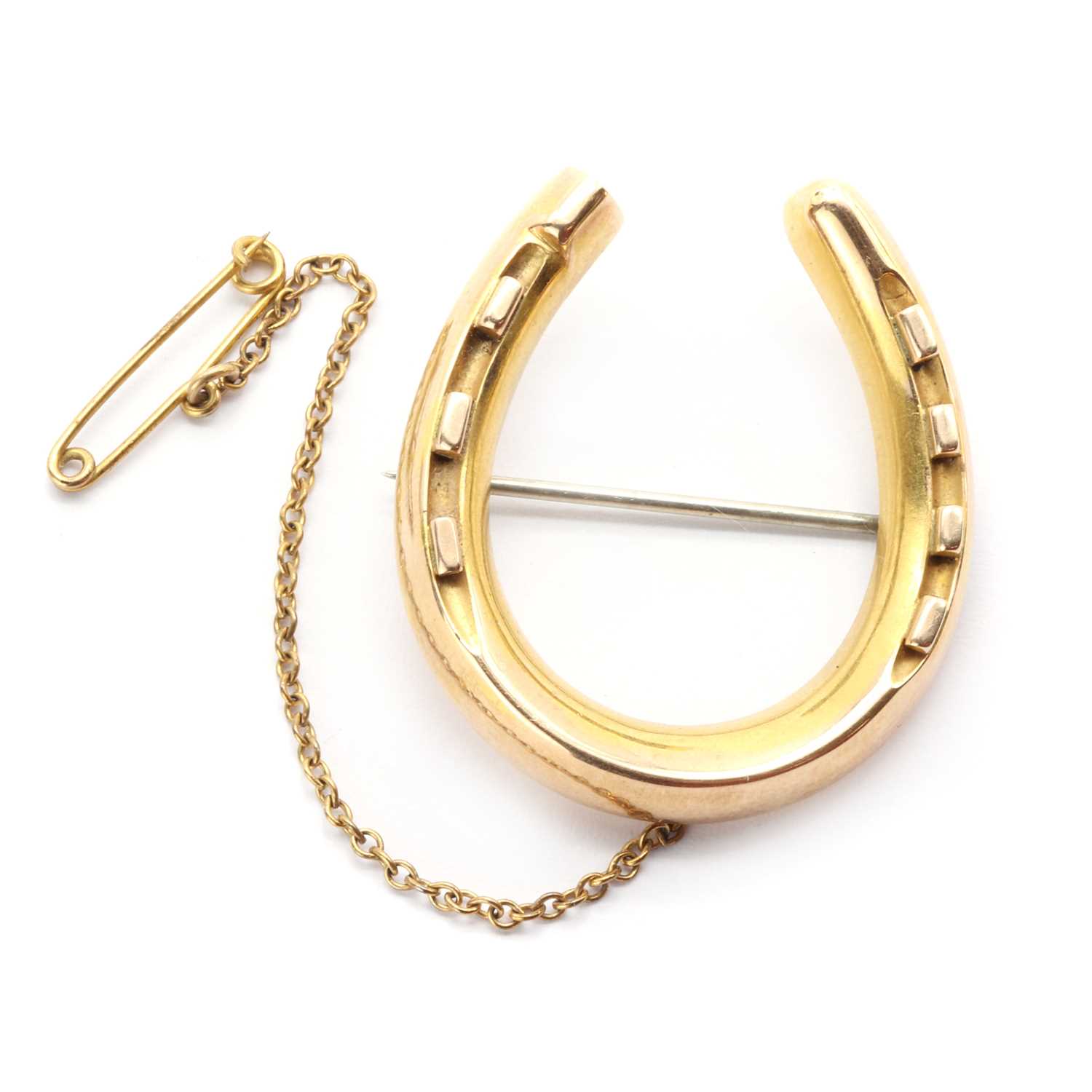 A Victorian gold hollow horseshoe brooch,
