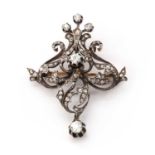 An Art Nouveau gold and silver diamond set brooch/pendant,