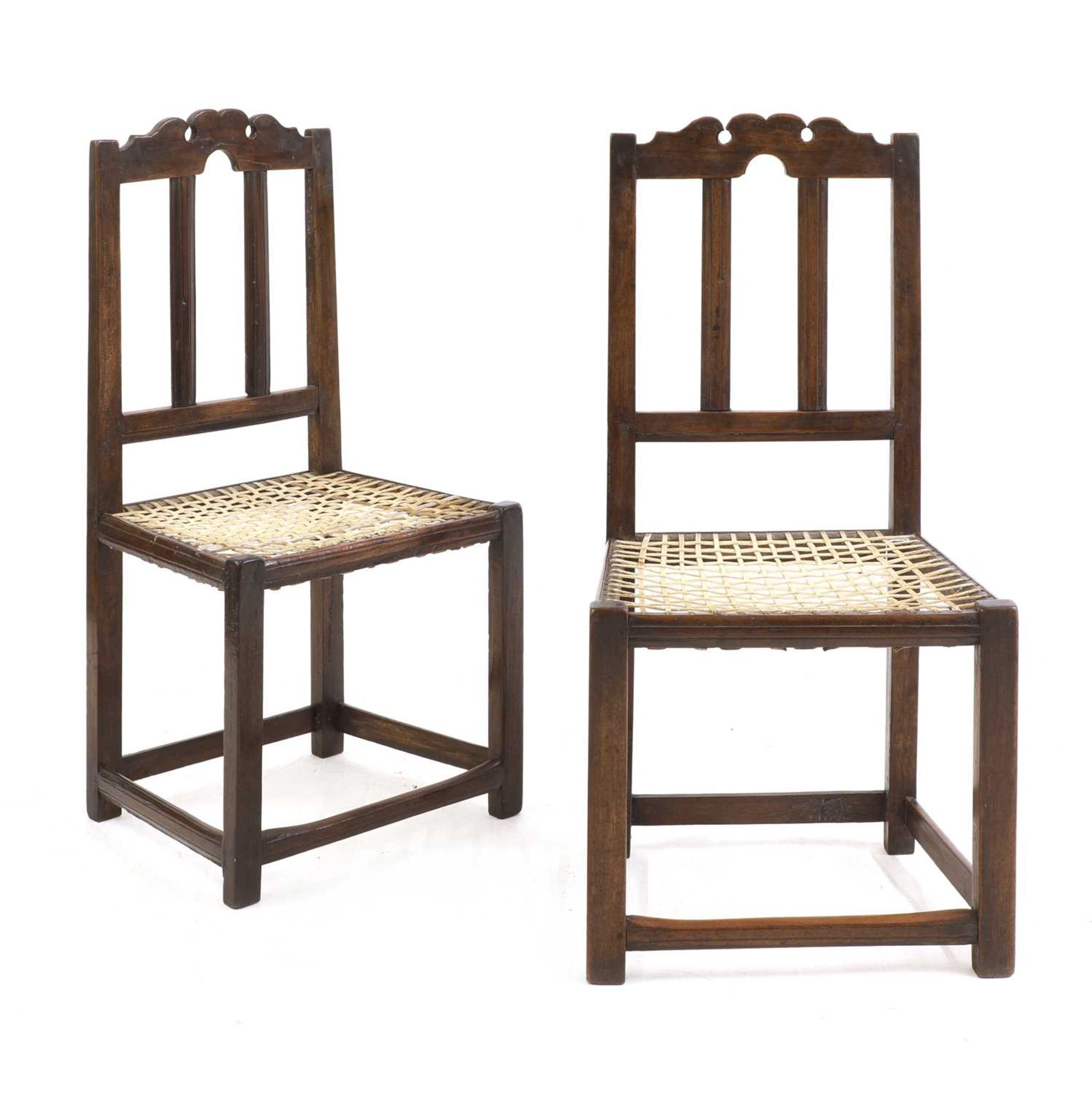 An unusually large pair of hardwood chairs,