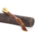 A gold-mounted pipe tamper,