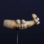 A boar's tusk/tooth ear pendant 'Ha'akai' with three 'Tiki figures',