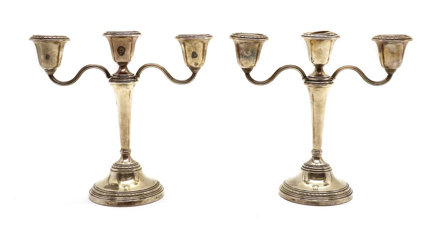 A pair of silver three branch candlesticks