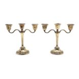 A pair of silver three branch candlesticks