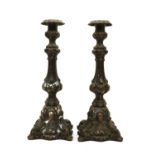 A pair of cast metal candlesticks