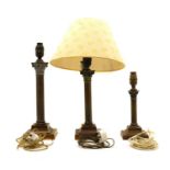 A near graduated set of brass Corinthian column table lamps,