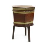 A George III mahogany and brass bound hexagonal wine cooler,