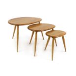 A nest of three Ercol elm and beech 'Pebble' tables