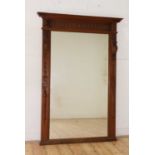 A large carved oak mirror