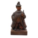 A Black Forest carved softwood 'whistling figure',