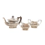 A silver three piece tea service