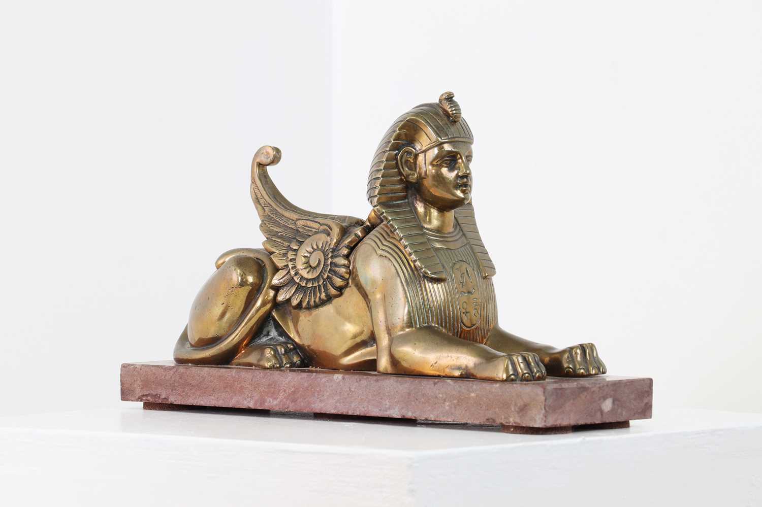 An Empire-style bronze figure of a sphinx,