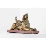 An Empire-style bronze figure of a sphinx,