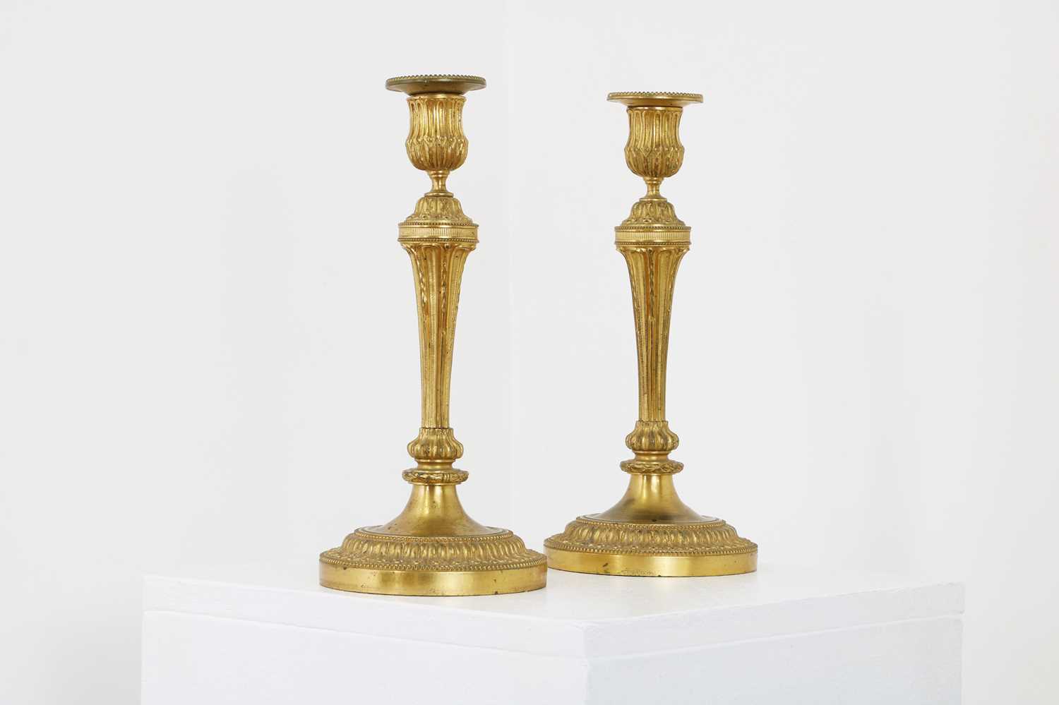 A pair of Louis XVI-style gilt-bronze candlesticks,