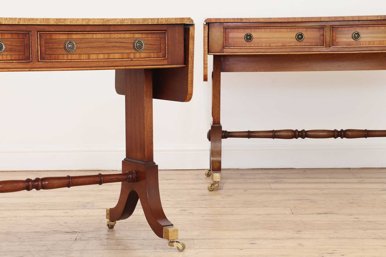 A pair of Regency-style rosewood and satinwood crossbanded sofa tables,