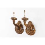 A pair of carved giltwood wall lights,