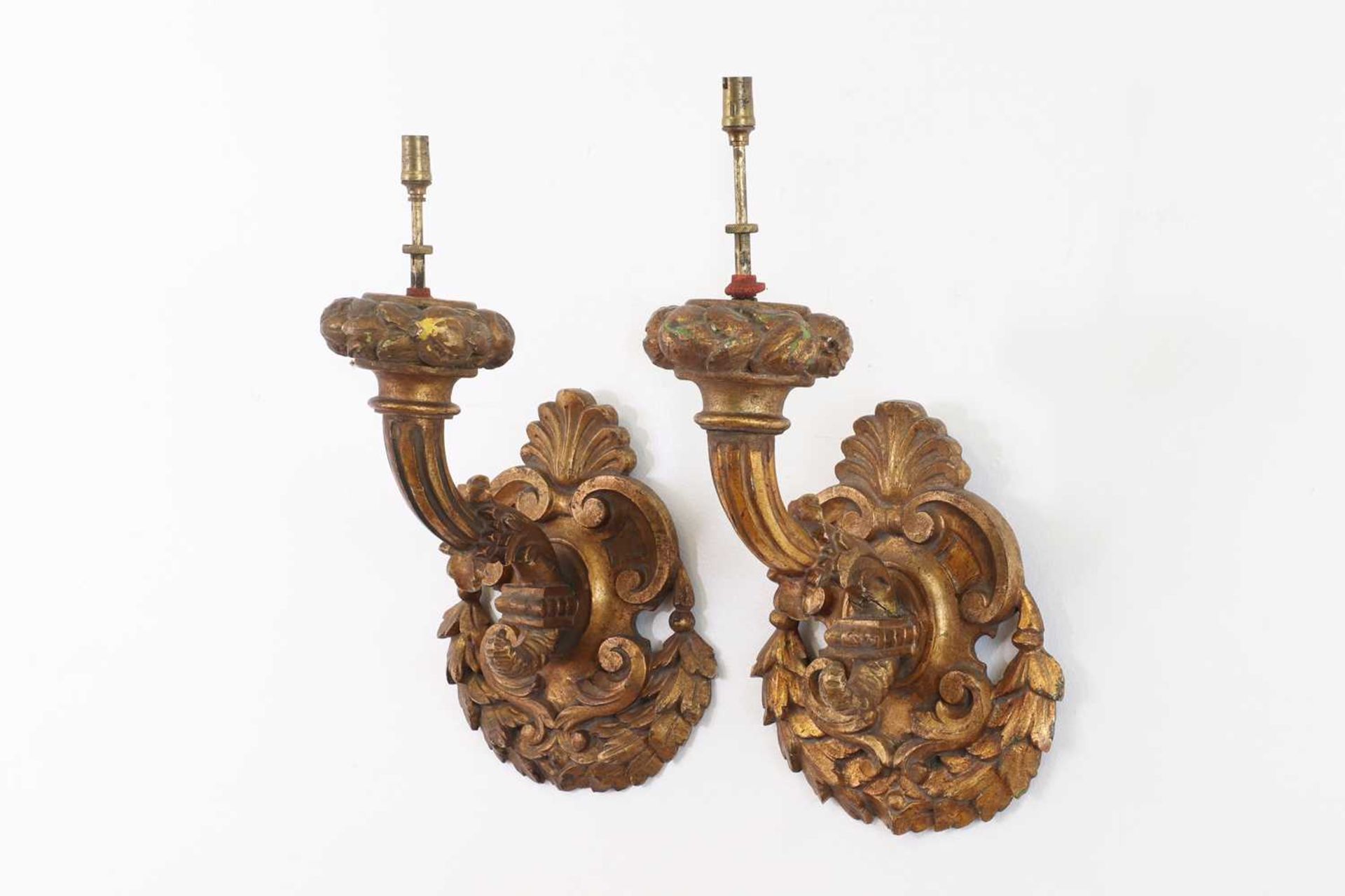 A pair of carved giltwood wall lights,