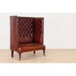 A buttoned-leather high-back wing chair,