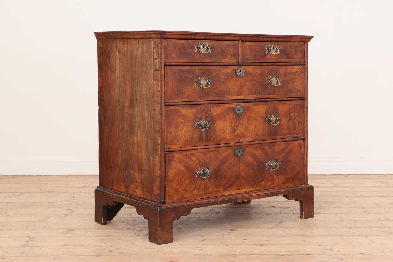 A Queen Anne walnut and feather-banded chest of drawers,