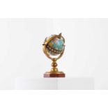 An enamelled brass globe clock,
