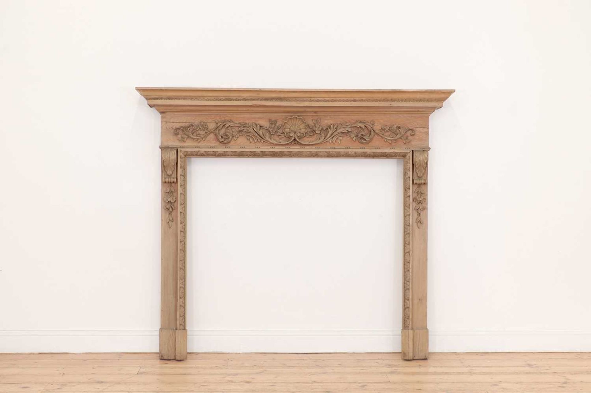 A George II-style carved pine fire surround,