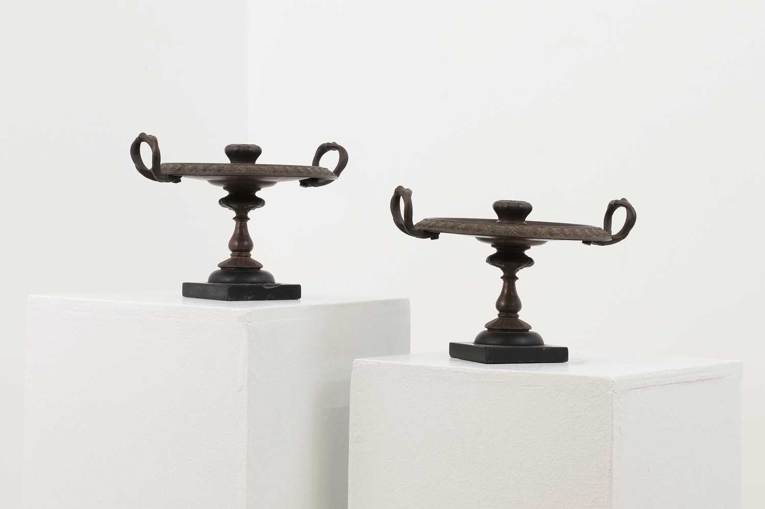 A pair of bronze candlesticks after the antique,