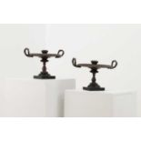 A pair of bronze candlesticks after the antique,