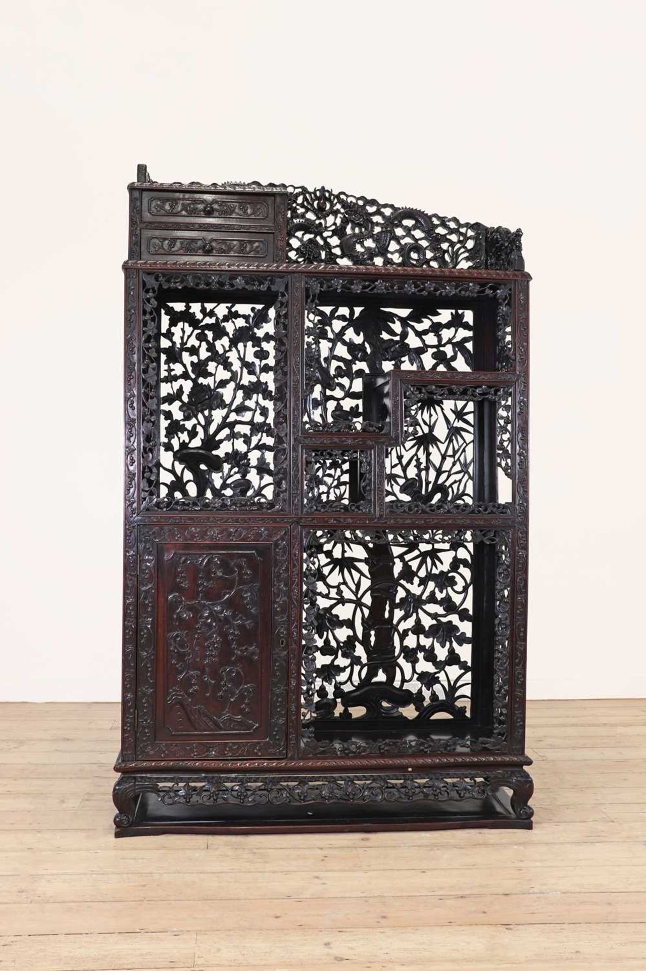 A carved and pierced hardwood cabinet,