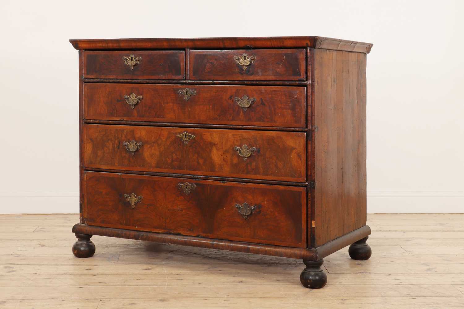 A William and Mary walnut and feather-banded chest of drawers,