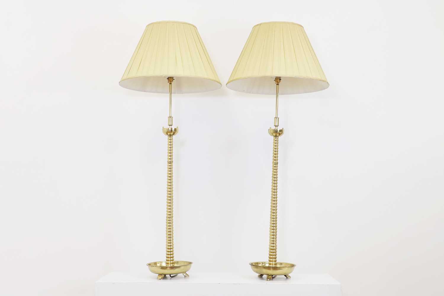 A pair of Dutch-style tall brass altar stick lamps,