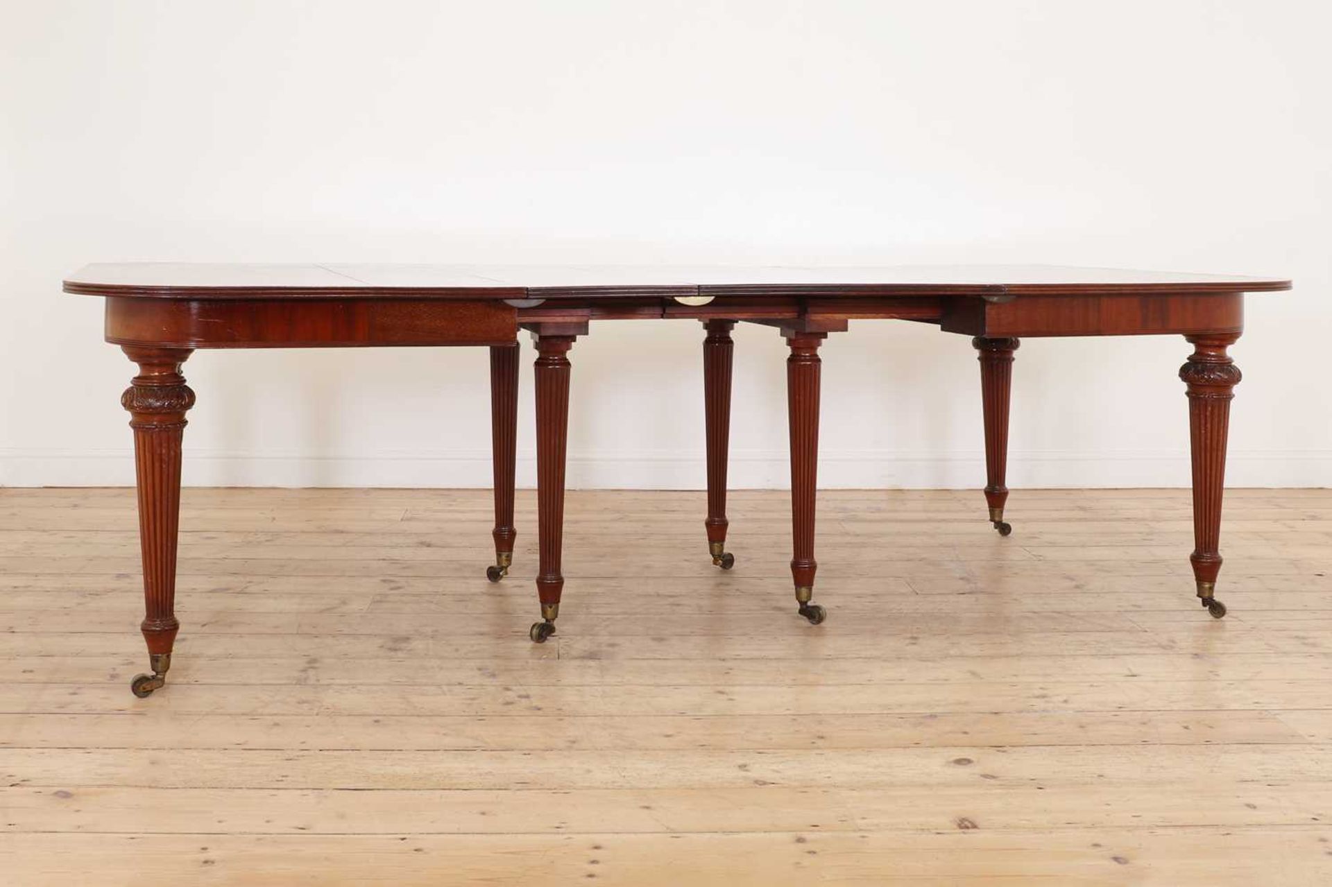 A mahogany extending dining table in the manner of Gillows,