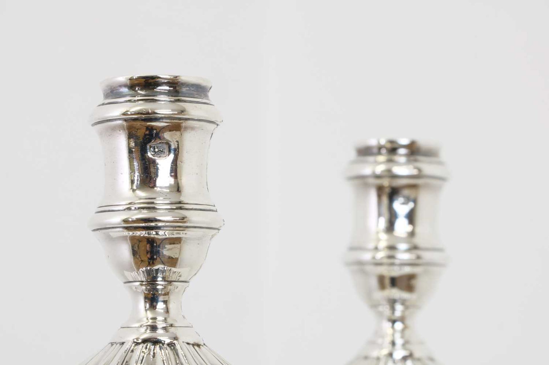 A pair of George II silver table candlesticks,