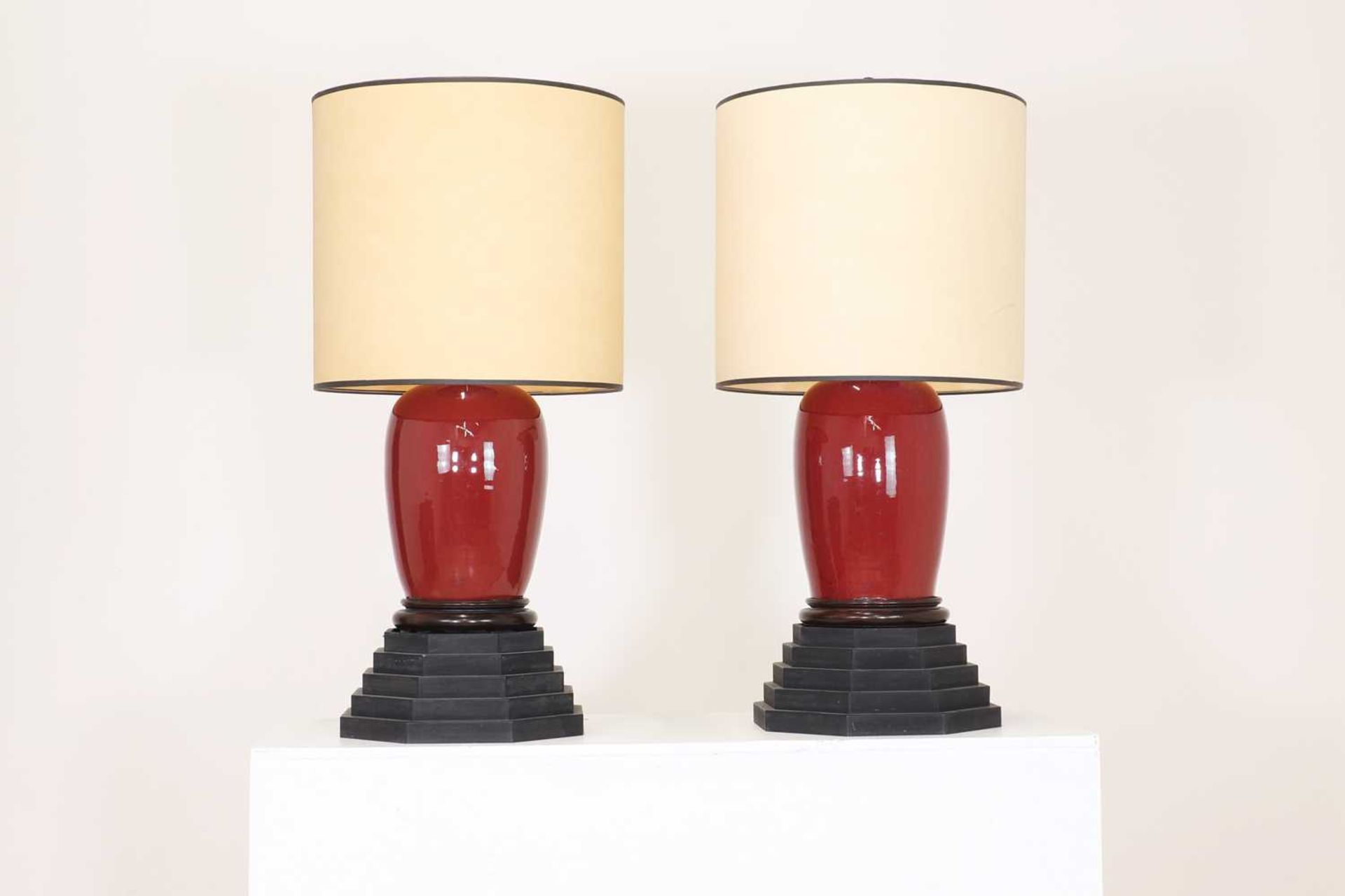 A near pair of sang-de-boeuf glazed porcelain table lamps,