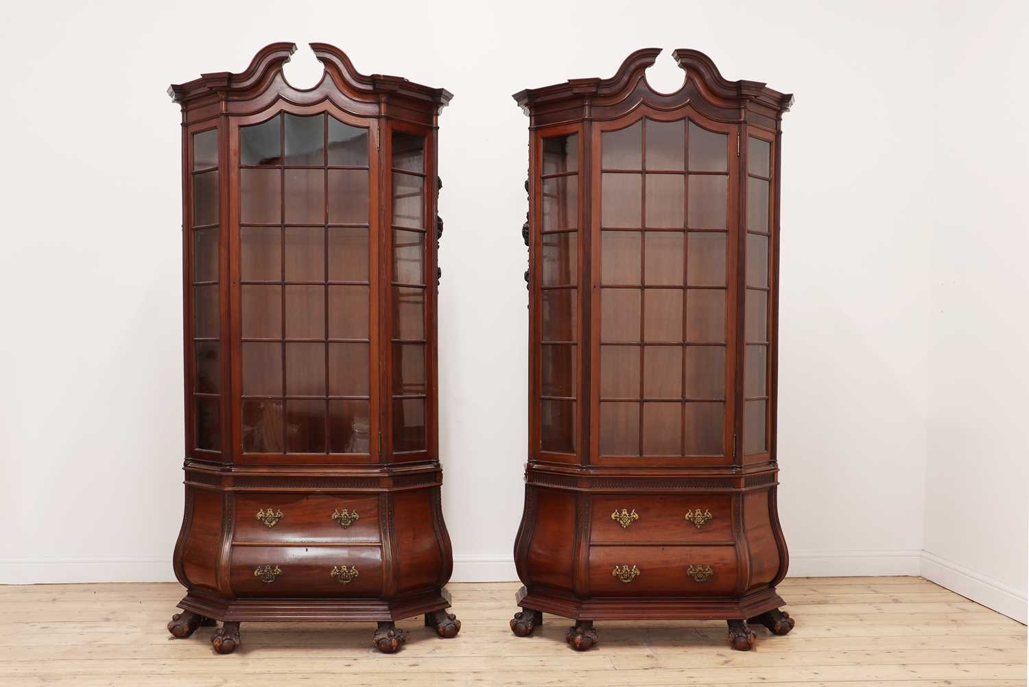 A pair of Dutch-style walnut vitrines by Gillows of Lancaster,