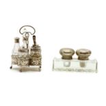 A silver cruet stand containing five silver mounted glass bottles