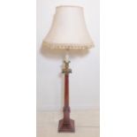 A brass-mounted turned mahogany lamp standard with shade; the patinated brass modelled as a Doric