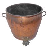 A late 19th / early 20th century two-handled riveted copper copper on lion's paw feet (35cm