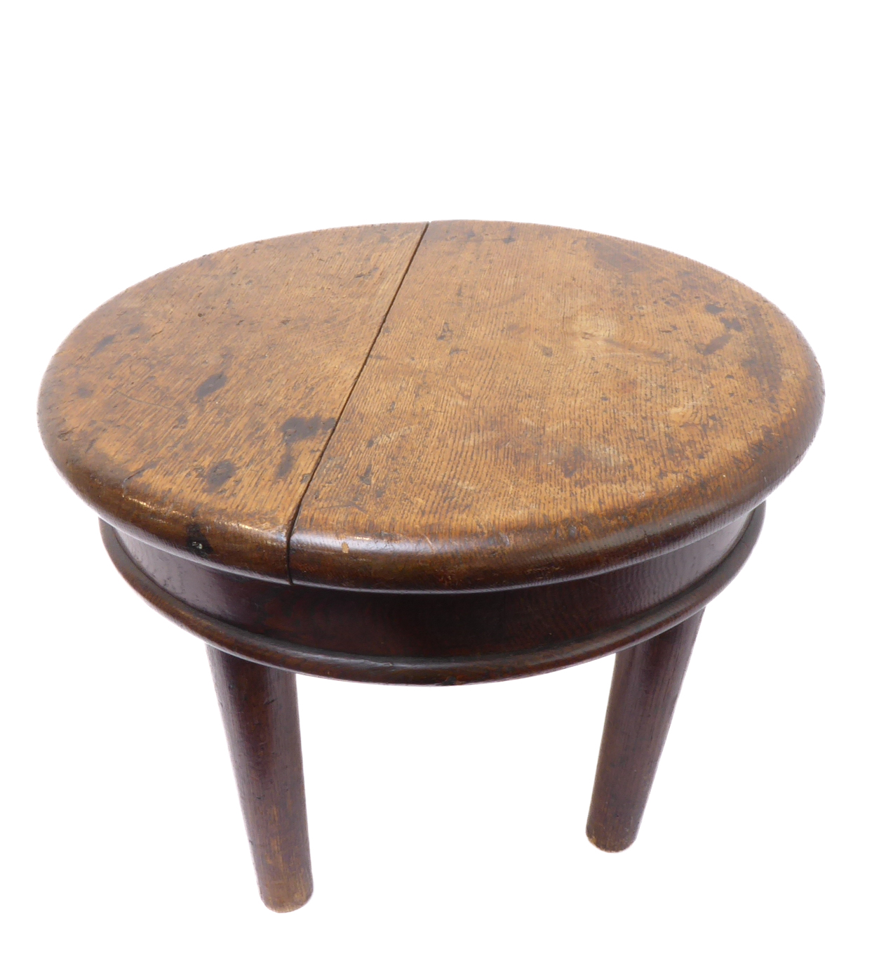 A circular and heavy oak occasional table raised on four turned, tapering legs (possibly late 18th/