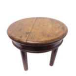 A circular and heavy oak occasional table raised on four turned, tapering legs (possibly late 18th/