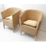 A pair of conservatory-style wickerwork tub chairs on turned wooden front legs (64cm wide)