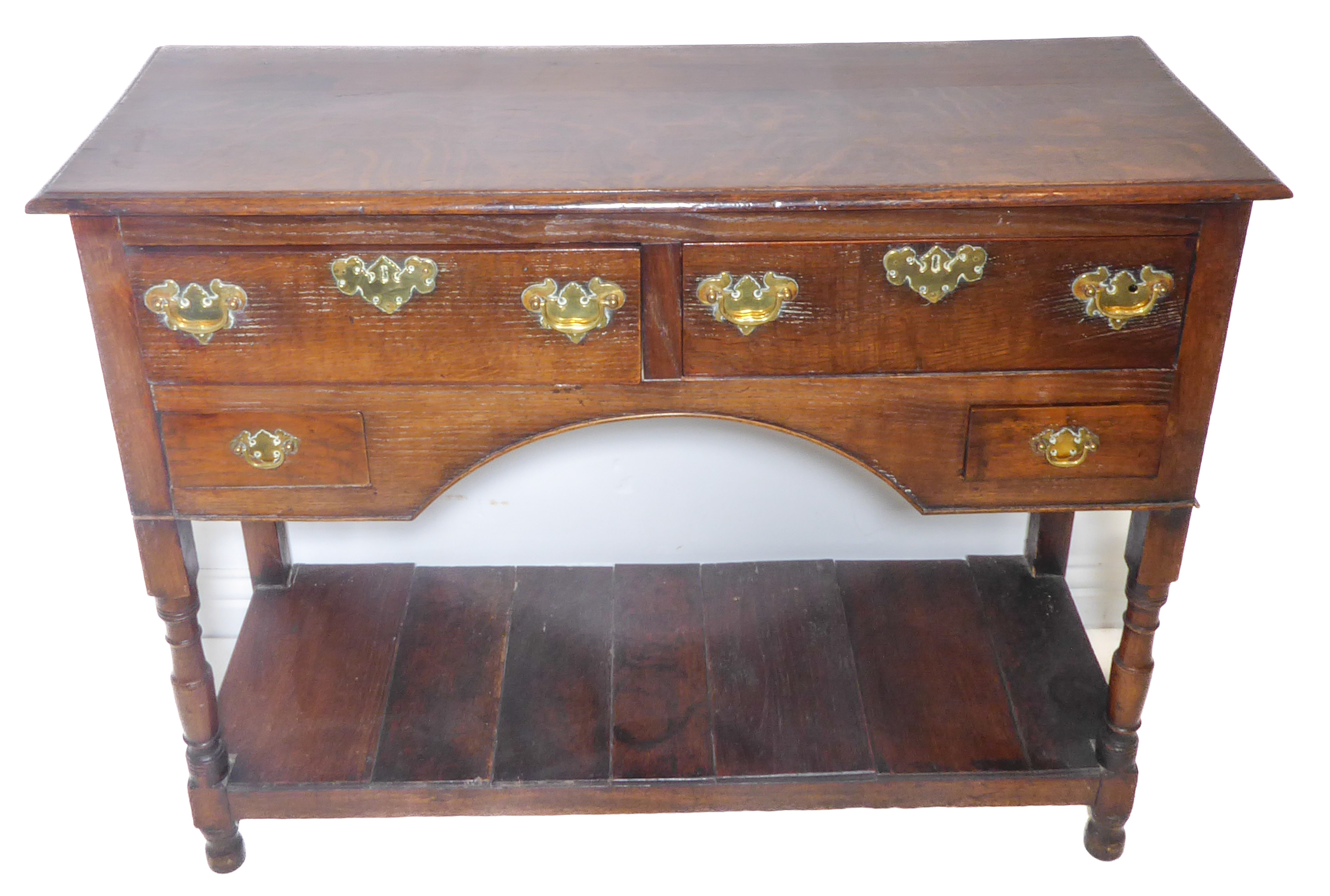 An antique oak dresser of small and pleasing proportions; the thumbnail moulded top above two half-