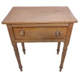 A 19th century pine side table; overhanging top over a full-width drawer and turned tapering legs (